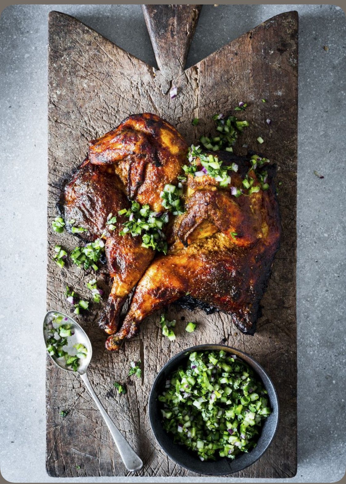 Spatchcock chicken with cucumber chimichurri, cooked live over the fire — The Asado.