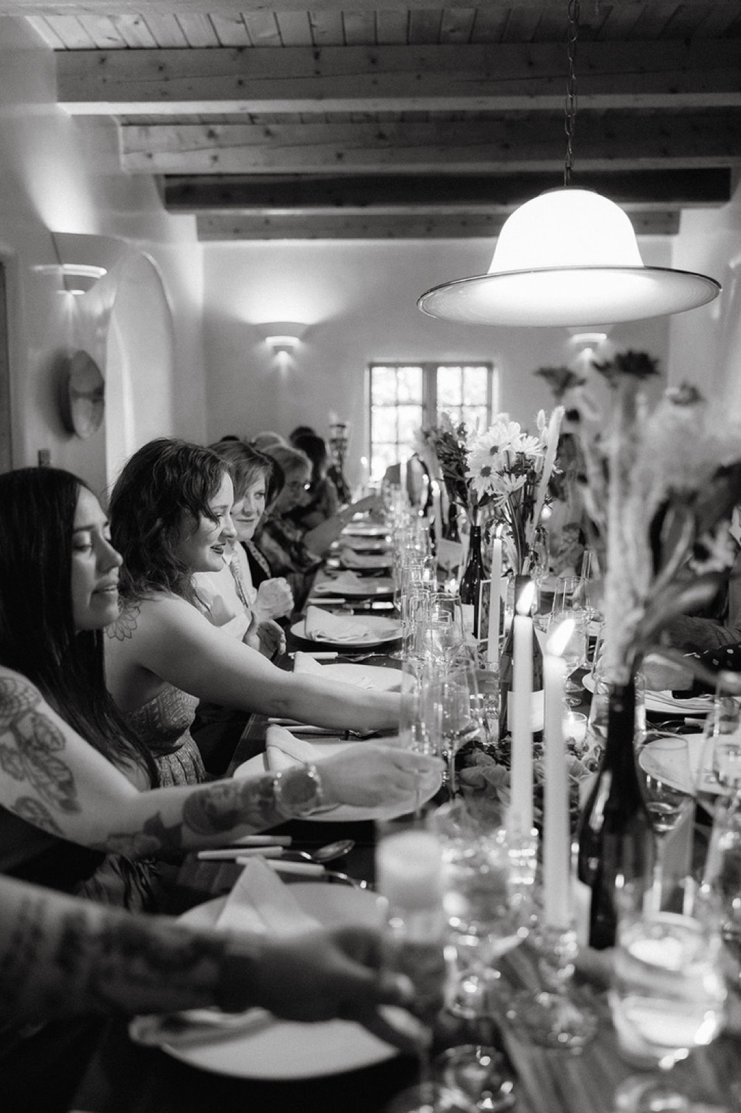 A candlelit five-course wine pairing dinner at Net Zero Ranch, in black and white.