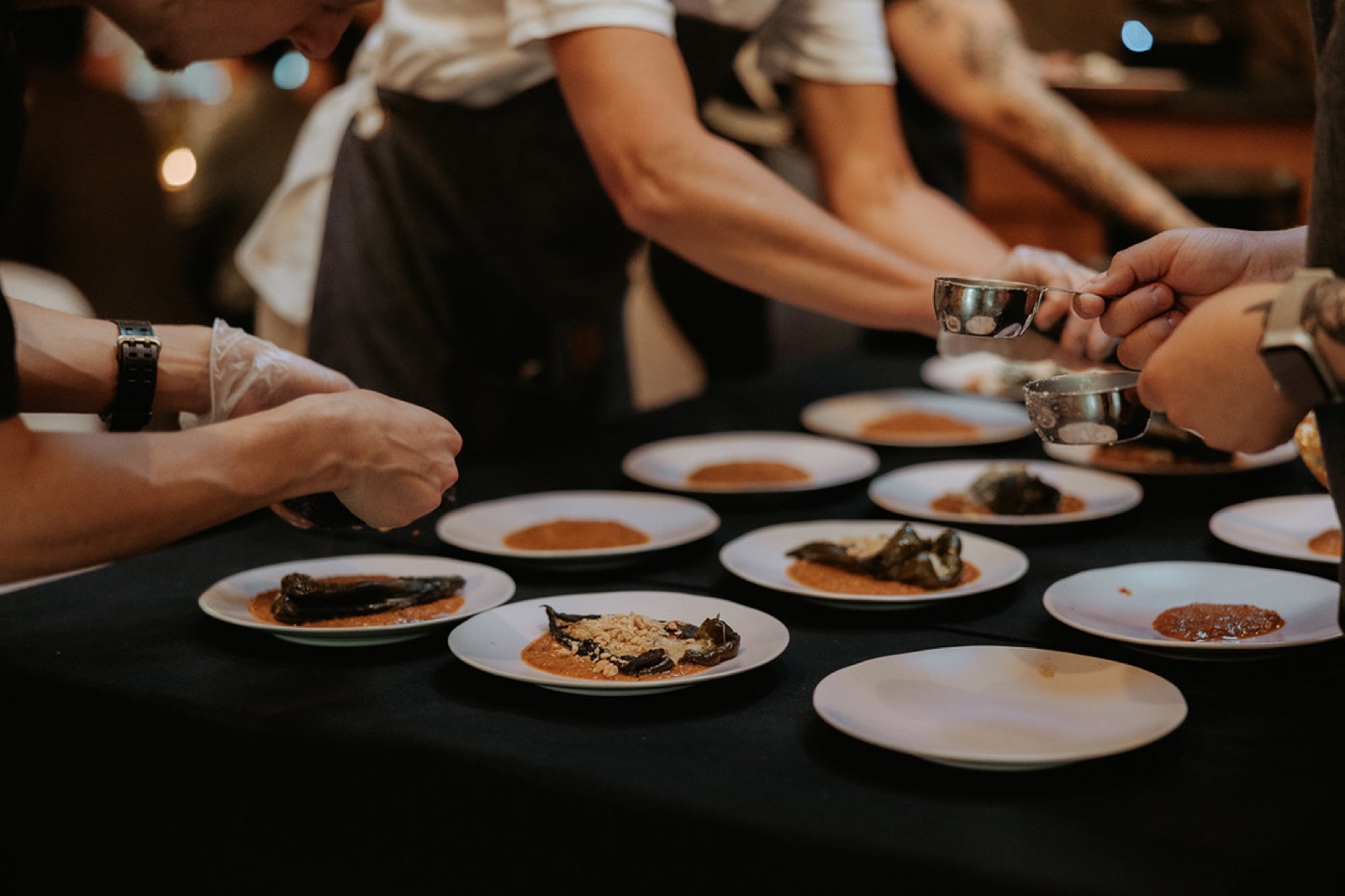 The Net Zero Ranch crew plating a chile course, spooned to order.