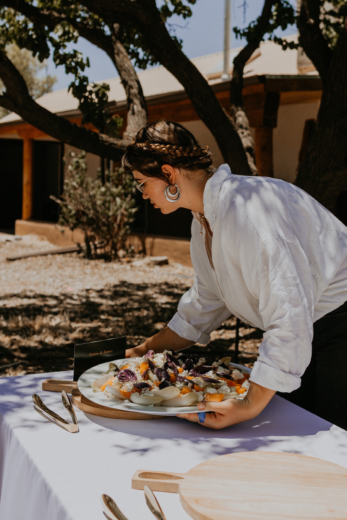 A Net Zero Ranch crew member setting out a styled platter.