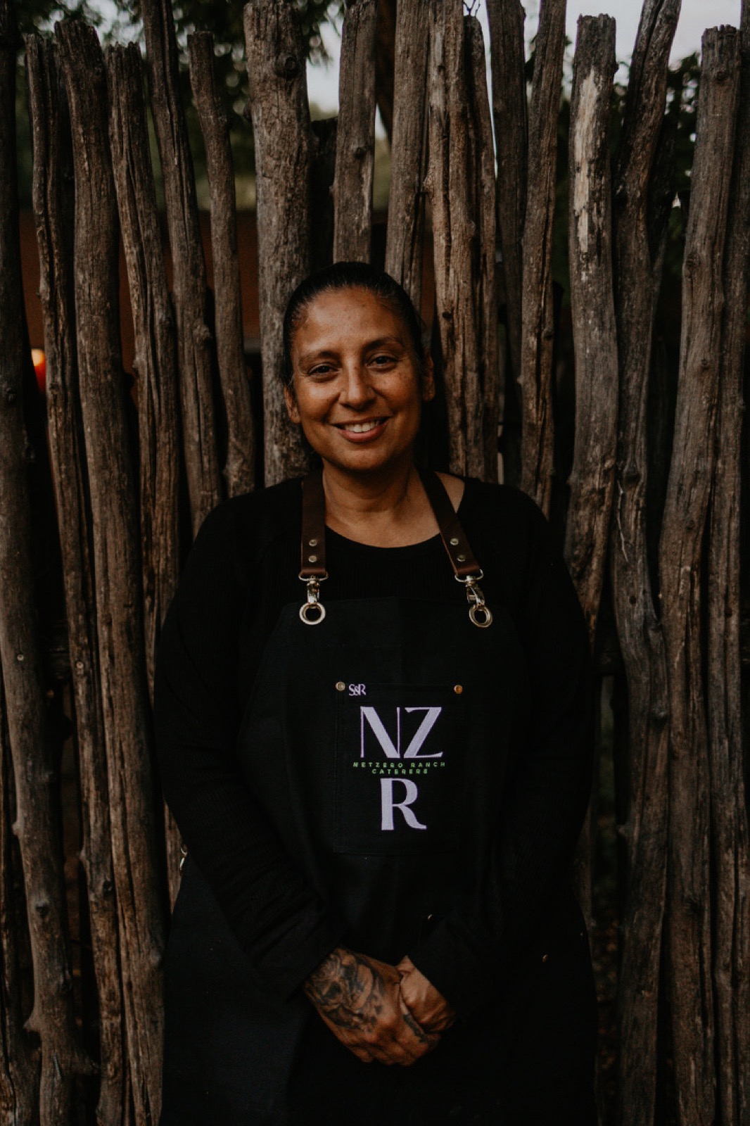 A Net Zero Ranch crew member in the NZR apron, portrait.
