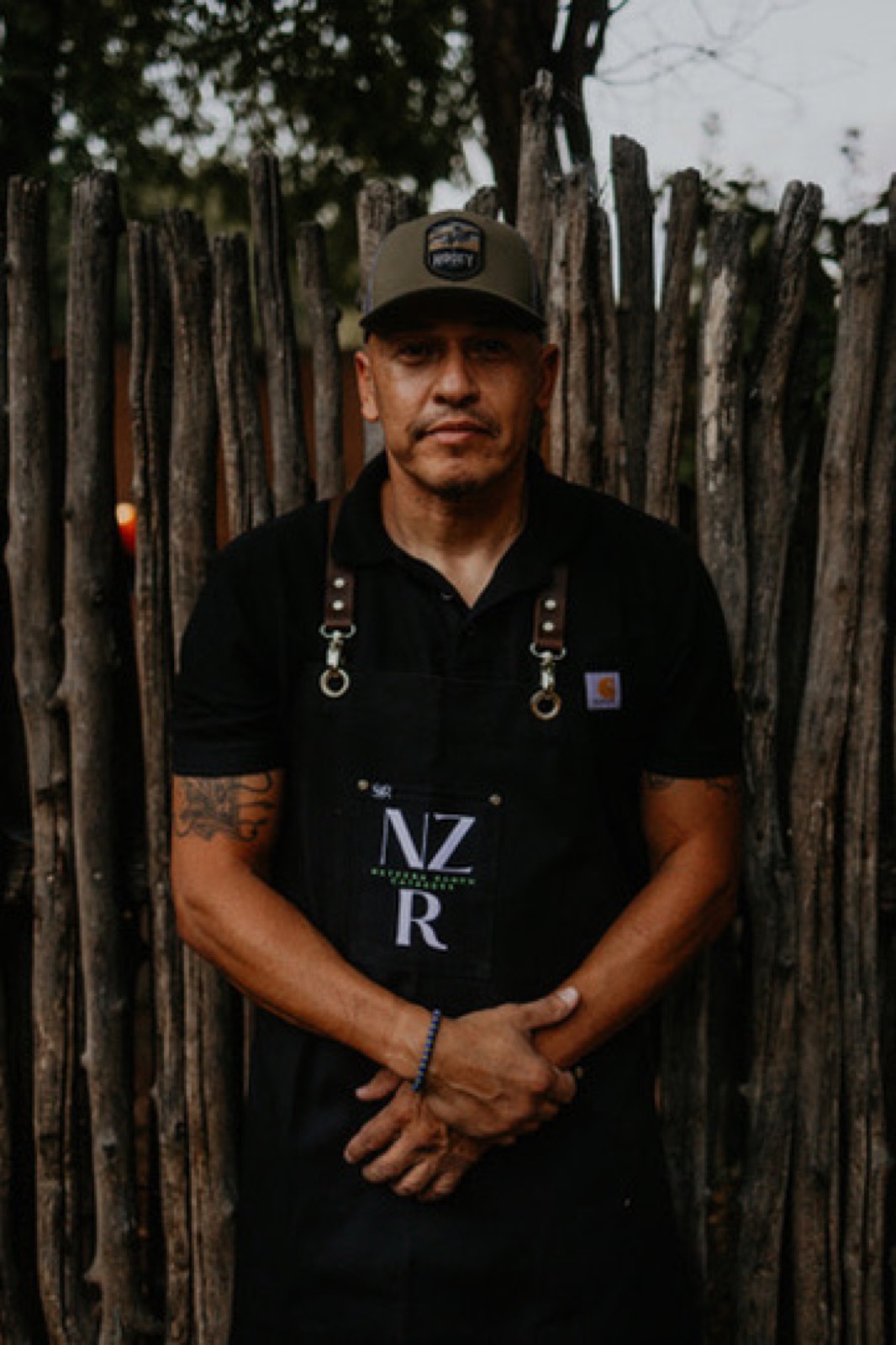 A Net Zero Ranch crew member in the NZR apron, portrait.