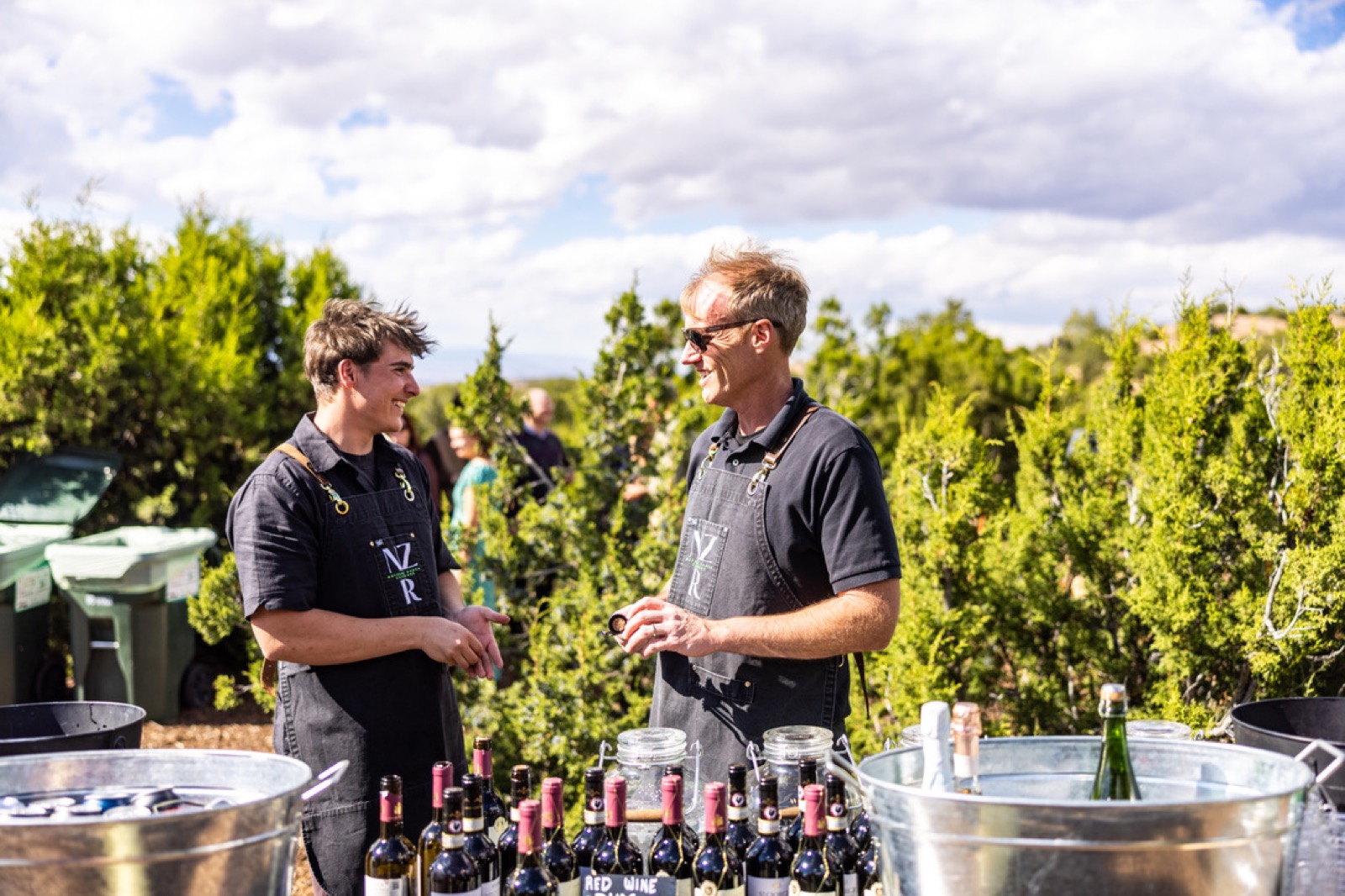 Two Net Zero Ranch crew members at the outdoor wine station.