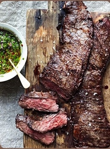 Wood-grilled skirt steak with chimichurri — The Asado table.