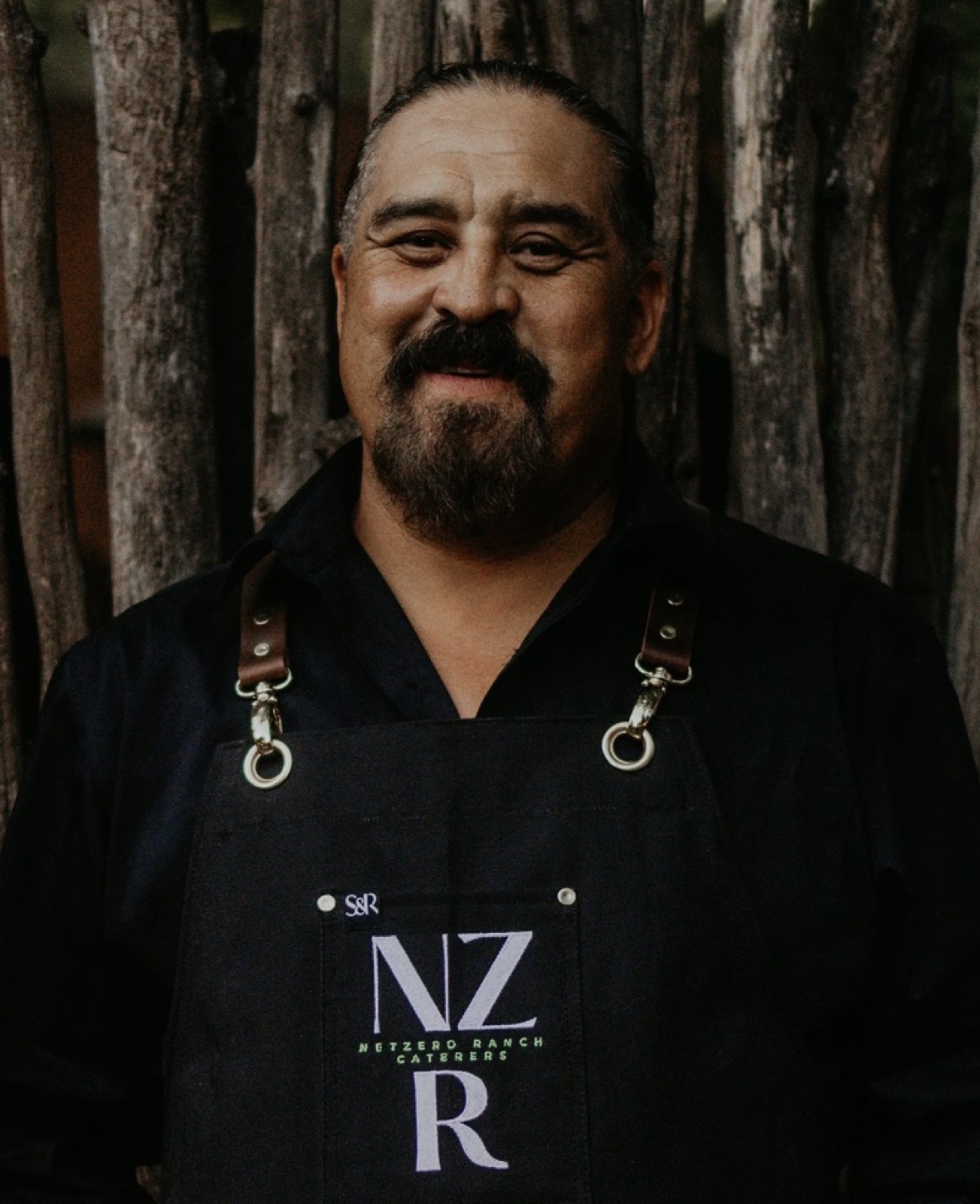 A Net Zero Ranch bartender in the NZR apron.