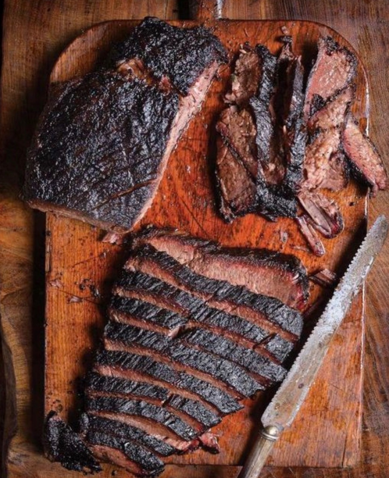 Slow-smoked brisket, sliced on the board — The Charro signature.