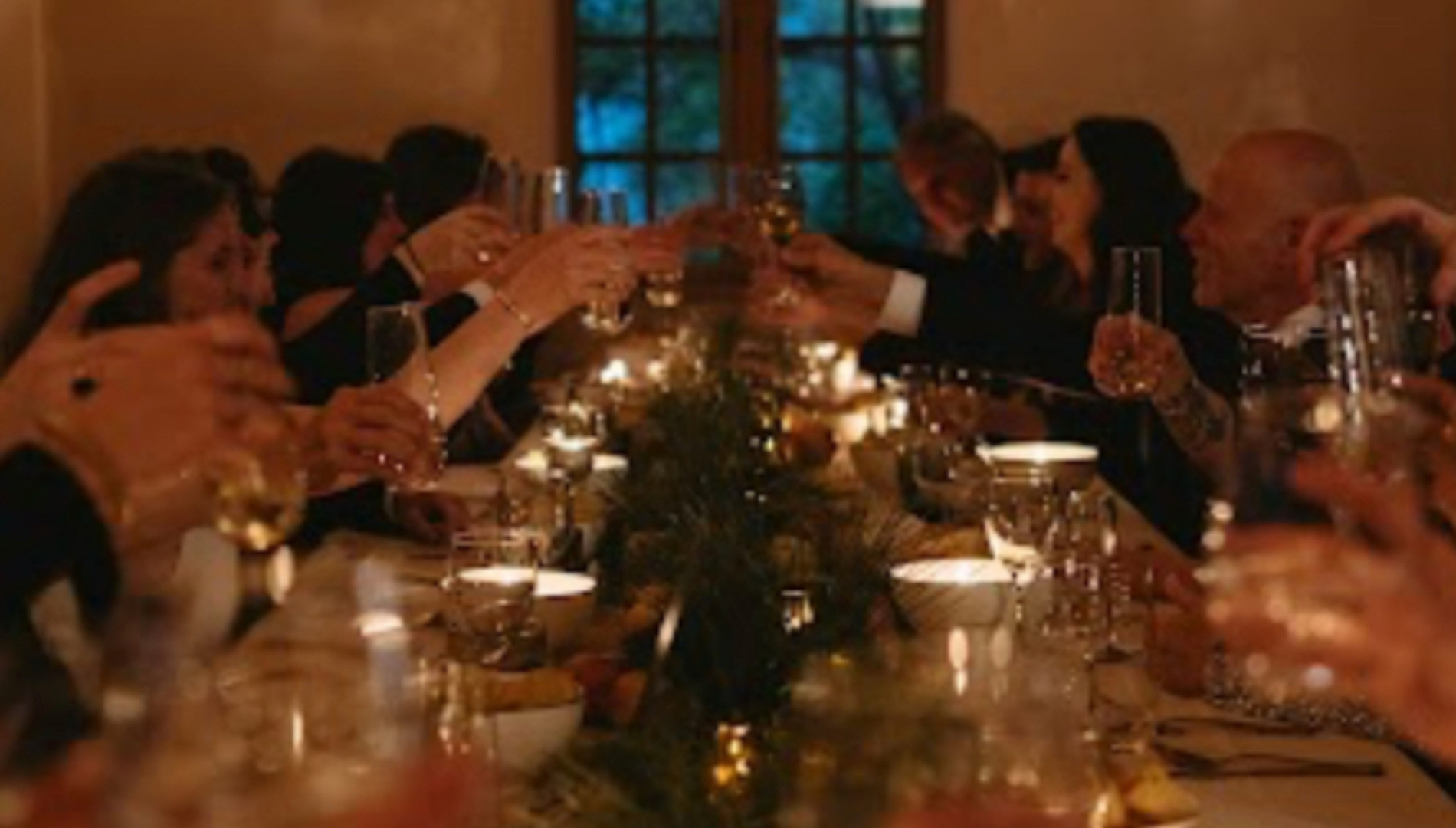 Guests raising a toast by candlelight at a Net Zero Ranch five-course wine pairing dinner.
