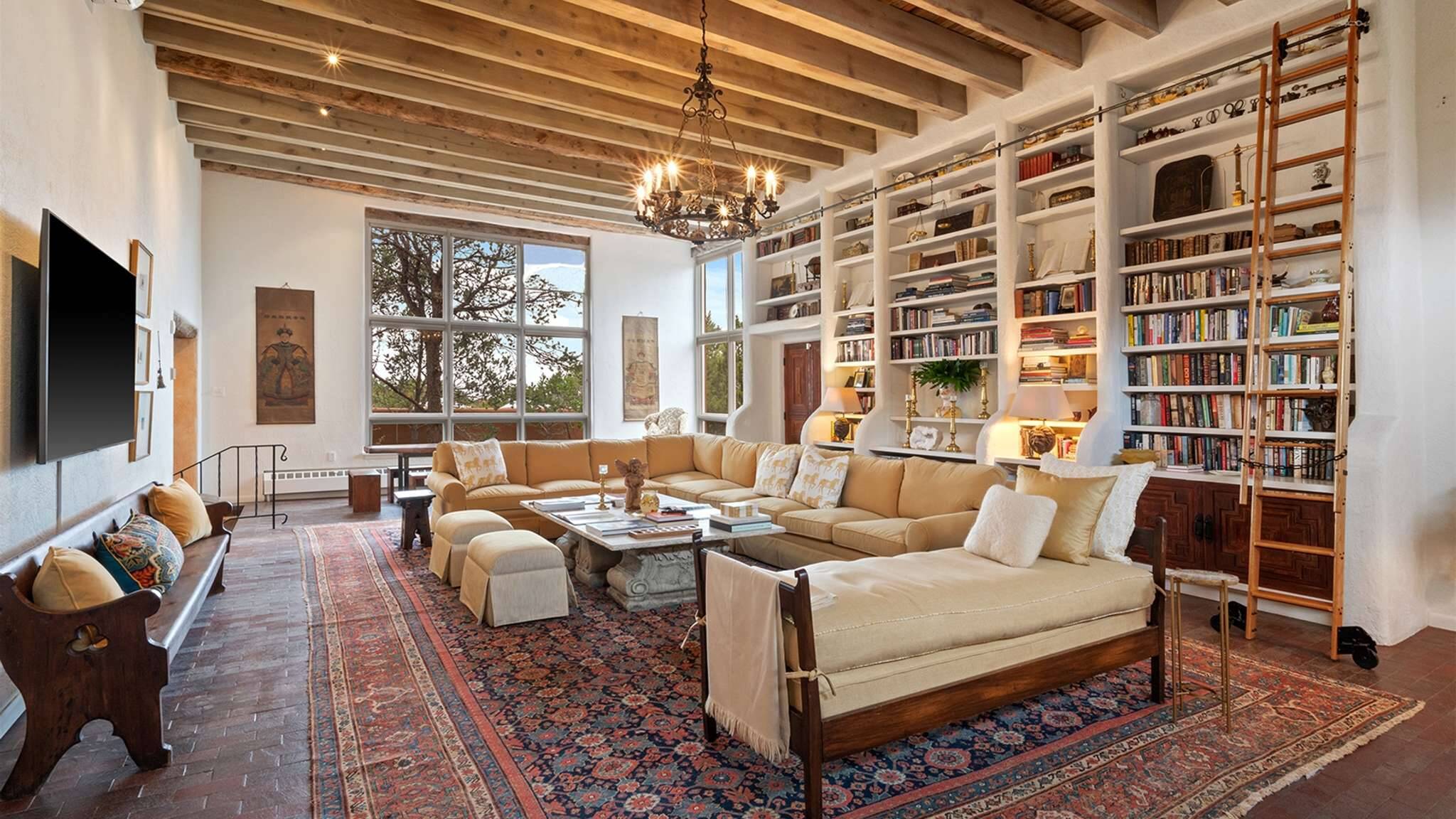 Cinco Chimineas, Santa Fe — historic library interior with vigas.