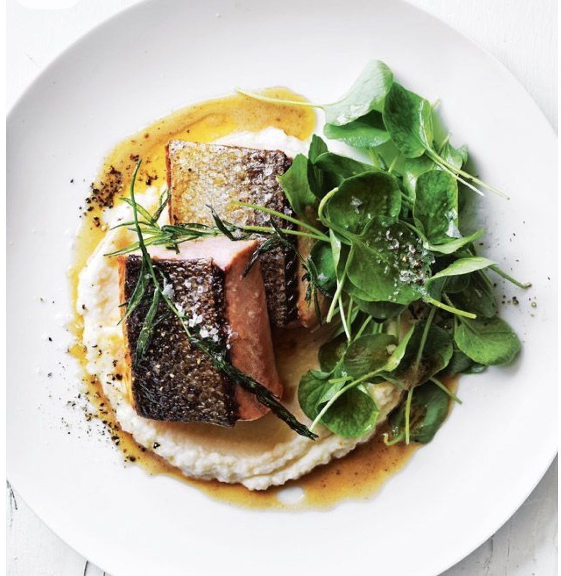 Crispy-skin salmon over creamy cauliflower purée with watercress and tarragon — Vacation Chef dinner.