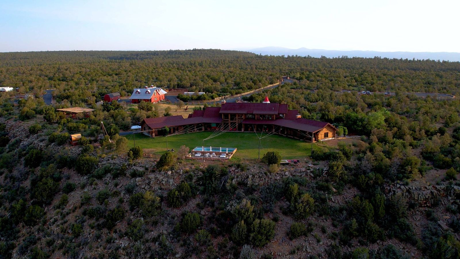 Aerial view of Blame Her Ranch, a private ranch wedding venue in the piñon and juniper hills of Ribera, New Mexico.