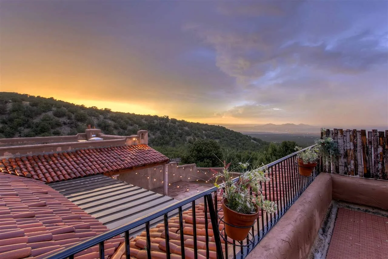 Hacienda Doña Andrea — rooftop patio with terra cotta tiles and 120-mile mountain views, Albuquerque.